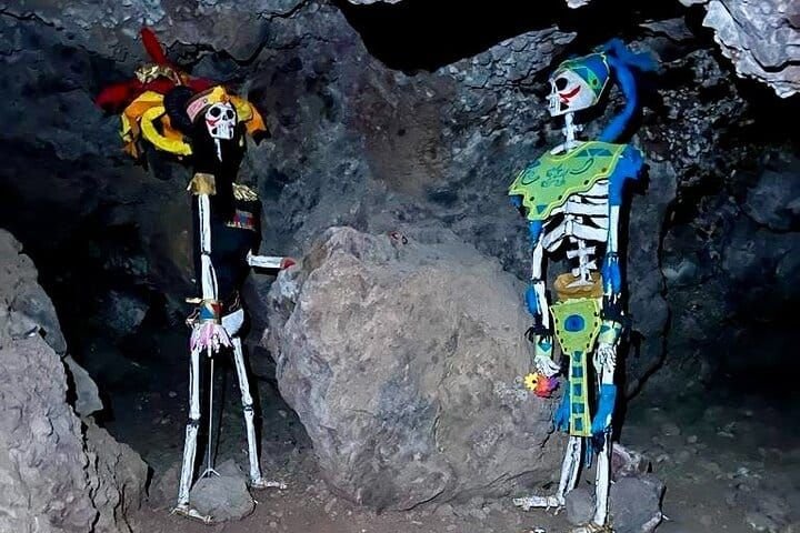 Dos catrinas decoradas de tamaño real montadas dentro de la cueva